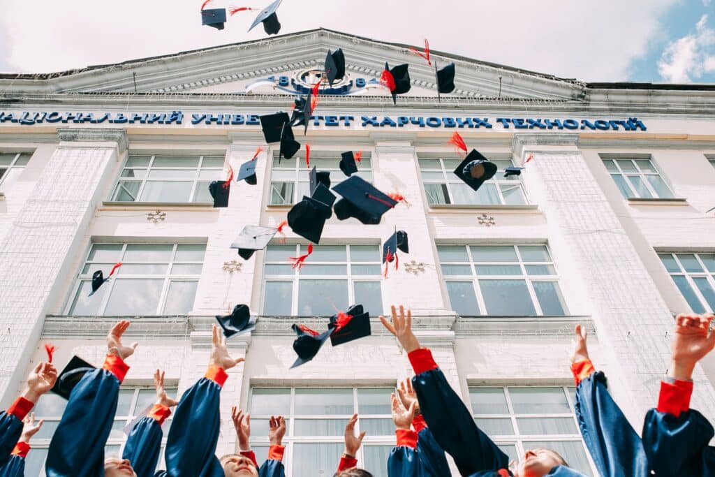 People graduating and throwing their caps in the air